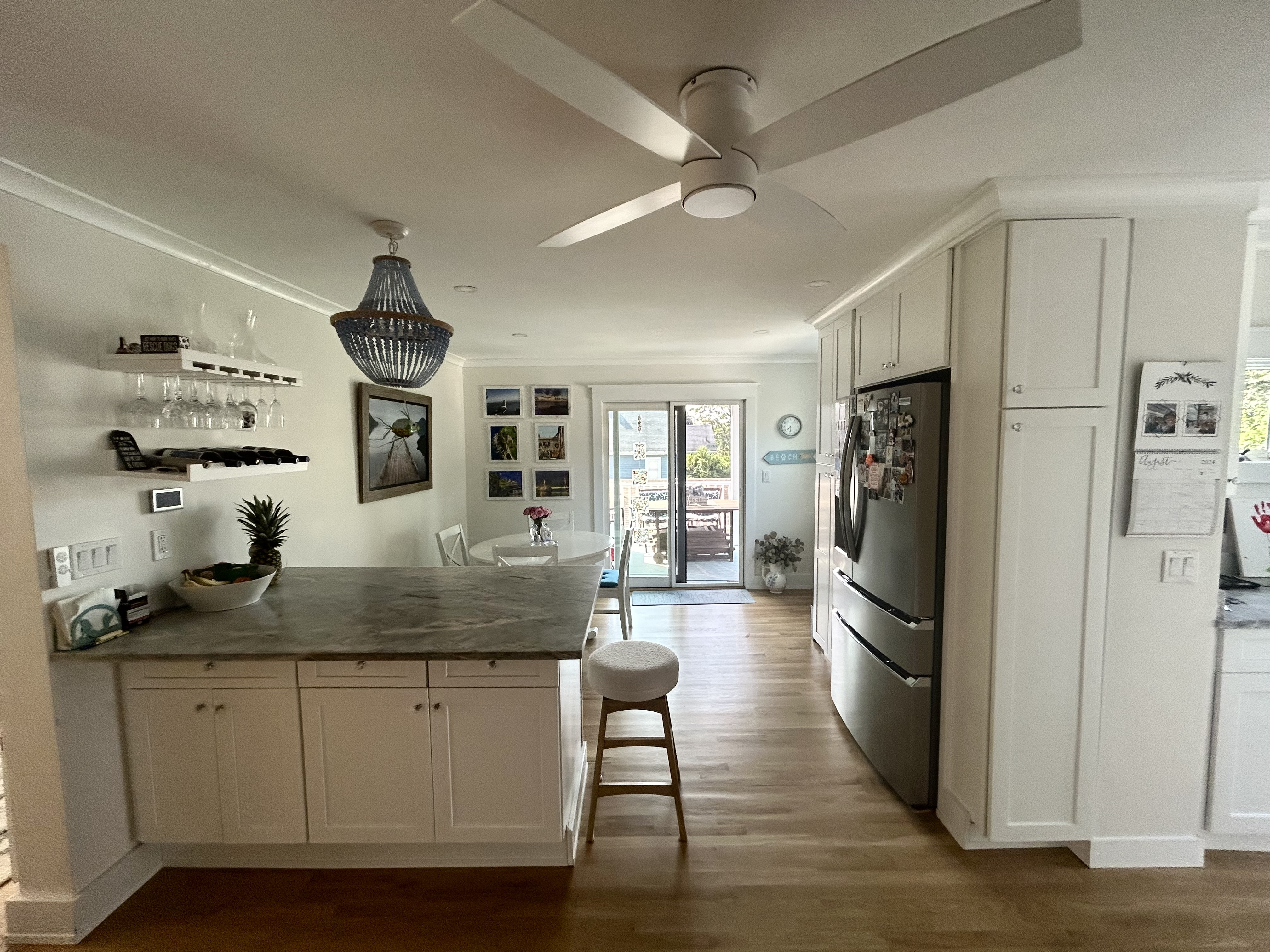 Nahant kitchen remodel with white shaker cabinets and marble-look island