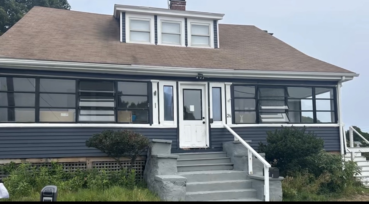 Blue-sided bungalow before the home remodel and addition by Bulldog Construction