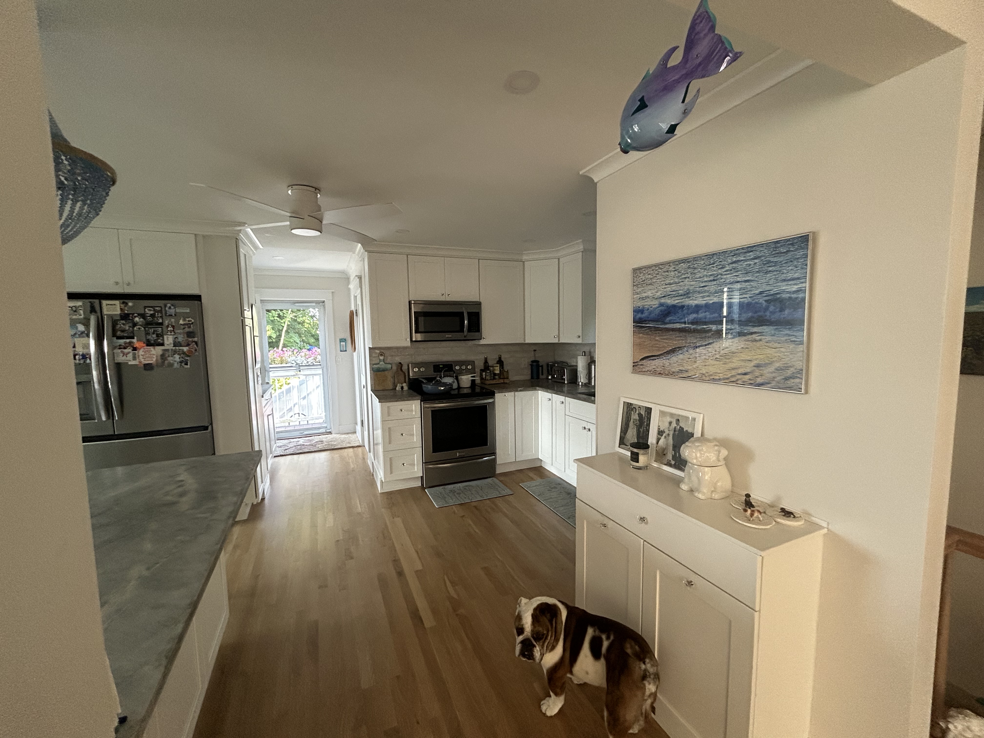 Kitchen renovation with contrasting dark island and white perimeter cabinets