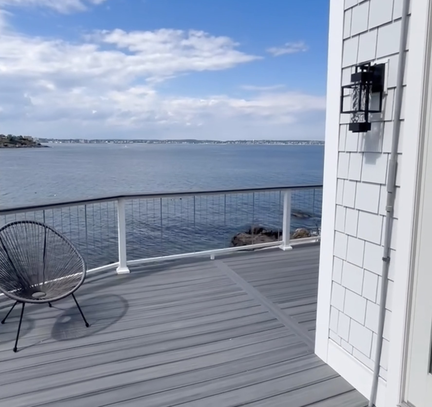 Completed waterfront deck renovation with ocean view by Bulldog Construction in Nahant, MA