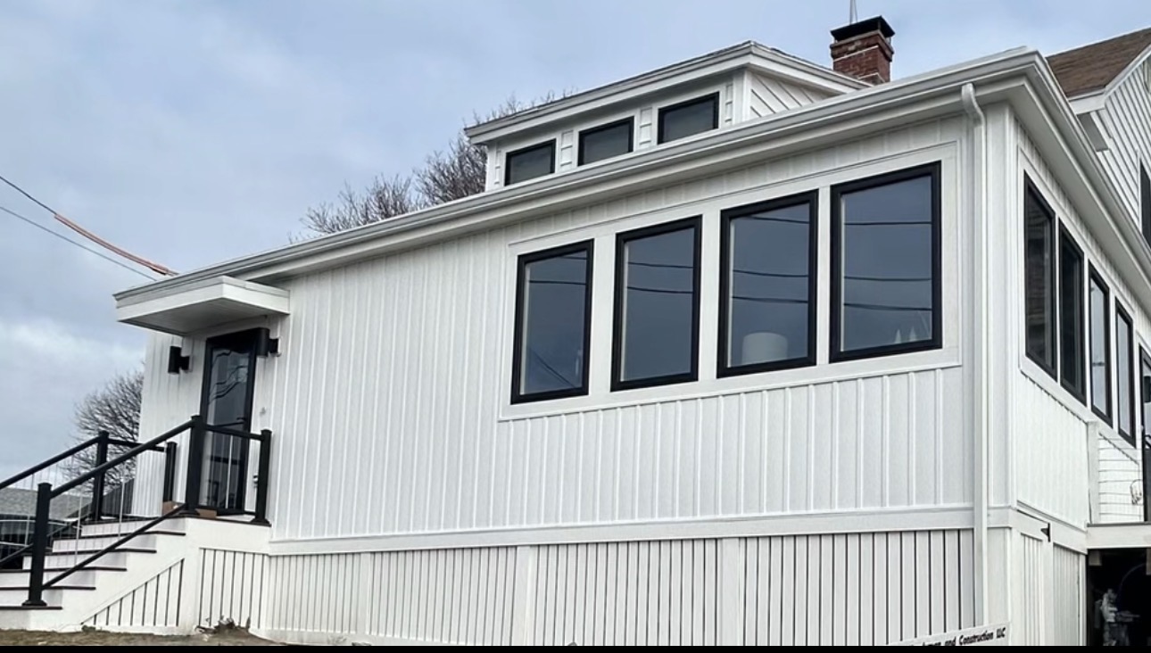 Renovated white home with a completed addition by Bulldog Construction