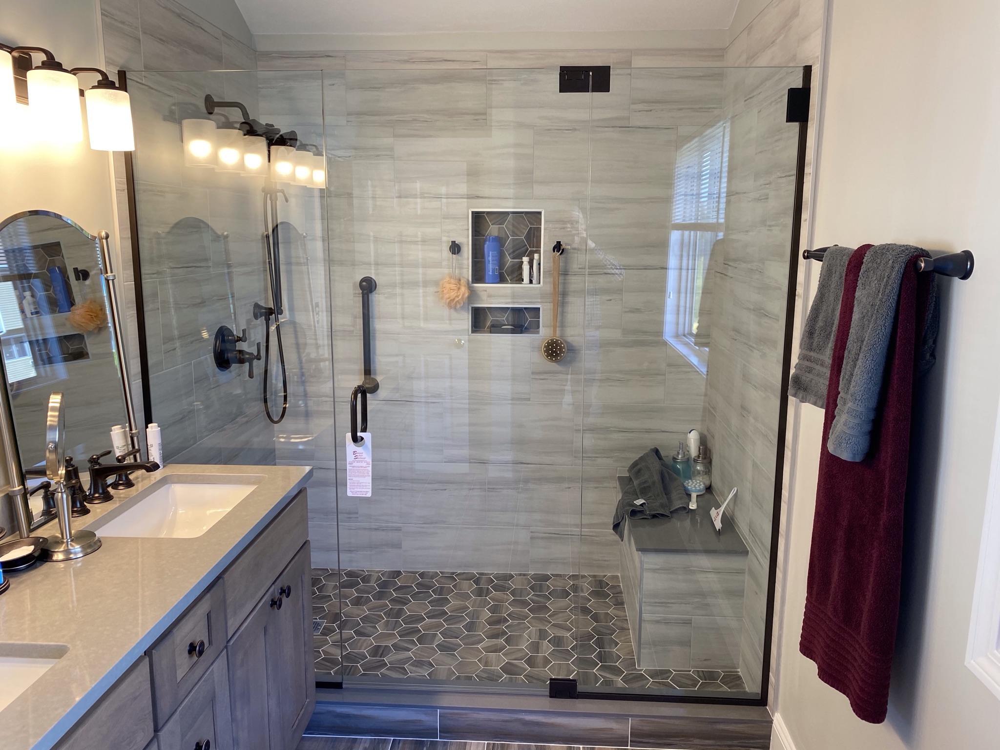 Walk-in marble-look tile shower renovation by Bulldog Construction