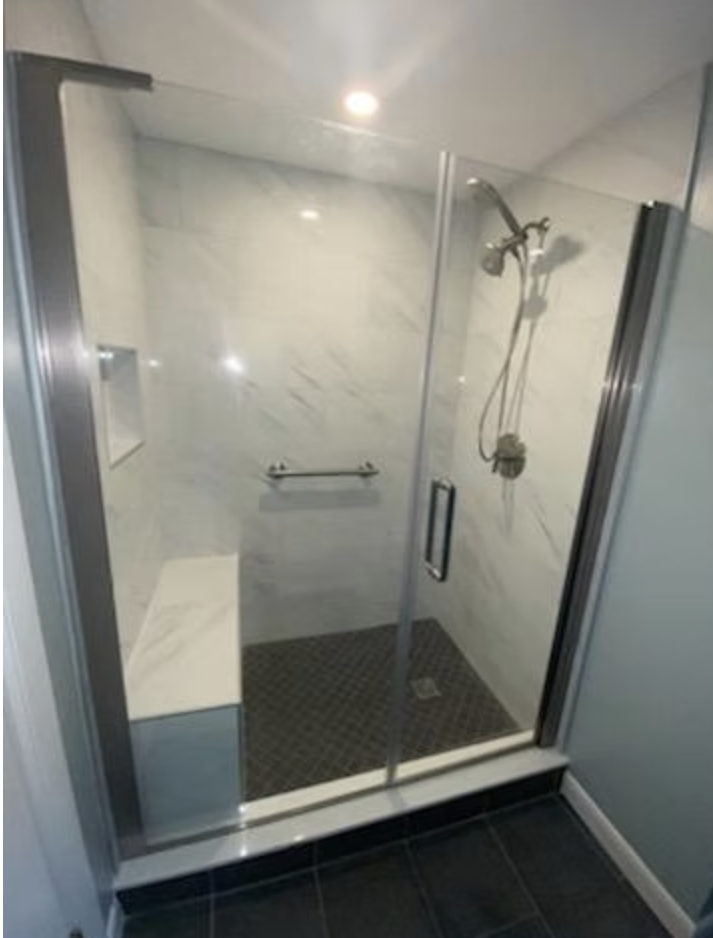 Walk-in shower with marble tile and glass enclosure renovated by Bulldog Construction